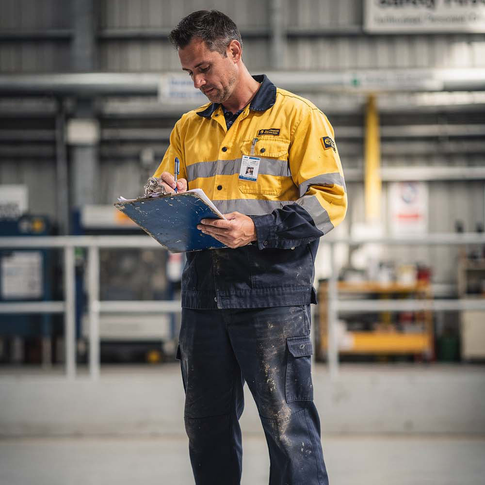 man recording with clipboard